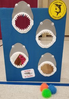 a cardboard box that has different types of shark teeth on it and some balls in front of it