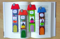 an open book with felt houses on it