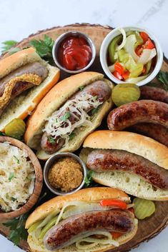 a platter filled with hot dogs, coleslaw and pickles