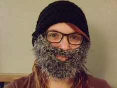 a man with long hair and glasses has a fake beard