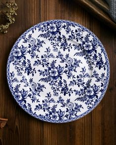 a blue and white plate sitting on top of a wooden table