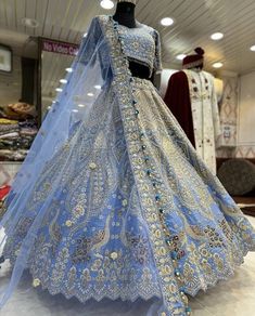 a blue bridal gown on display in a store