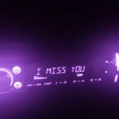 the word i miss you is projected in purple light