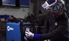 a man in a helmet working on a machine