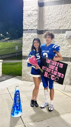 two girls in football uniforms are holding signs and posing for the camera while one girl holds a sign that says, i don't know if you cant