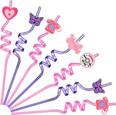 a bunch of pink and purple hair clips on a white background with a button in the middle