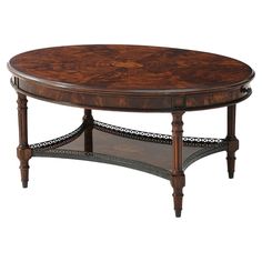 a wooden table with an oval top and ornate carvings on the bottom, sitting against a white background