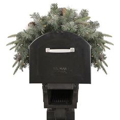 a black box oven with pine cones on top