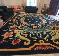 a living room with a large rug on the floor