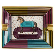 a decorative plate with a horse painted on the front and sides in multi - colored stripes