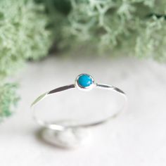 Tiny skinny stackable ring with beautiful bright blue turquoise stone (Country of Origin US). It is made with a skinny but sturdy band, which allows you to create mind-blowing stacking sets! The ring is ideal for everyday wear and it will also look amazing with a festive dress. The ring is 0,8-0,9 mm thick and looks very dainty on the finger. Choose the size of the stone (3 or 5 mm) and the material for the ring (sterling silver or 9k gold). If you want to change the ring band design or get a cu Stackable Blue Turquoise Ring In Sterling Silver, Minimalist Stackable Turquoise Ring For Anniversary, Blue Gemstone Dainty Stackable Rings, Dainty Blue Gemstone Stackable Rings, Minimalist Turquoise Promise Ring With Birthstone, Minimalist Turquoise Promise Ring, Minimalist Turquoise Birthstone Ring, Dainty Stackable Turquoise Ring, Dainty Turquoise Stackable Ring