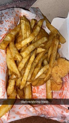 a basket filled with french fries next to a slice of pizza on top of a table