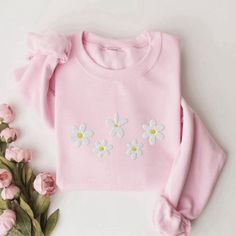 Introducing our Daisies Embroidered Sweatshirt, a delightful addition to your wardrobe that effortlessly combines comfort and style. This 2D Crewneck Sweatshirt is not only a fashion statement but also a thoughtful gift option for your loved ones. With meticulous attention to detail, this sweatshirt is designed to bring joy and warmth to your everyday attire, while showcasing your love for nature and its beautiful creations. Featuring a stunning embroidered daisies design, this sweatshirt immedi Spring White Sweater With Embroidered Logo, Spring Long Sleeve Tops With Embroidered Logo, Long Sleeve Tops With Embroidered Logo For Spring, Pink Sweatshirt With Embroidered Logo For Spring, White Sweater With Floral Embroidery And Crew Neck, White Crew Neck Sweater With Floral Embroidery, Spring Long Sleeve Sweater With Embroidered Text, White Sweater With Floral Embroidery, White Casual Sweater With Floral Embroidery