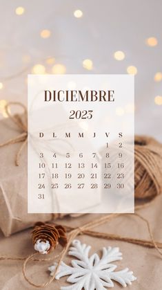 a calendar with a snowflake on it next to some twined twine