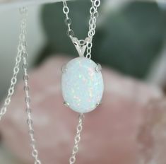 "Beautiful Large white lab-created opal pendant necklace. These gorgeous opals are very similar to natural mined opals. Lab-created opals contain 70-90% silica (from which natural opal is formed) and 10-30% resin. The resin makes the opal harder, stronger, unlike natural opals, which are known to be soft and fragile. Each opal displays a rainbow of color that sparkles with every catch of light. I've handset two different size opals in a solid sterling silver prong settings 16x12mm (5/8\" x 1/2\" White Opal Round Pendant Necklace, White Opal Pendant Jewelry, White Opal Gemstone Necklace, White Oval Opal Necklace, White Opal Necklace For Gift, White Pink Opal Gemstone Jewelry, White Ethiopian Opal Gemstone Jewelry, White Ethiopian Opal Gemstone Necklace, White Opal Cabochon Necklaces