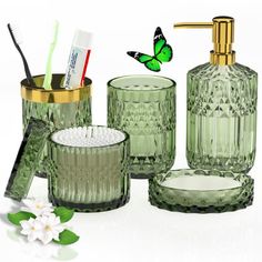 green glass bathroom accessories including toothbrushes, soap dispenser and cup