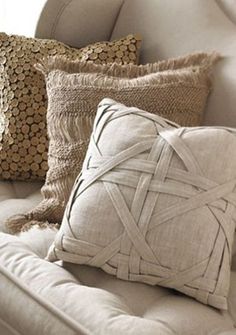 some pillows are sitting on a white couch