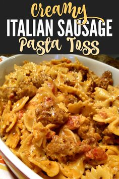 creamy italian sausage pasta toss in a white bowl on a colorful tablecloth with text overlay