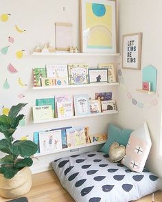 a child's room with bookshelves and toys on the shelves above it