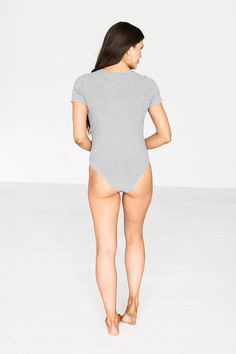 Grace & Lace Bodysuits are back! The Ribbed Henley Bodysuit is the perfect basic piece when you want a top to look fitted and sleek and not have to keep tucking it in. The soft ribbed knit fabric has plenty of stretch to keep you comfy with a rounded neckline and functional snaps for style versatility. Bikini bottom with easy to use bottom snap closure makes getting dressed a breeze. (This also provides for the optional wear of not using the snap closure portion and just tucking it in instead). Pair with shorts, skirts, jeans and any kind of jacket for a flattering, seamless look! Slim fit bodysuit with snaps detail at front neck and functional snap closure at the bottom. Knit fabric has good stretch, stay in your normal size. If between sizes and tall, you could size up. Model is 5'9 wear Stretch Bodysuit With Lined Body For Loungewear, High Stretch Lined Bodysuit For Loungewear, High Stretch Bodysuit With Lined Body For Loungewear, Stretch Cotton Bodysuit With Lined Body, Lined Loungewear Bodysuit In Solid Color, Solid Loungewear Bodysuit With Lined Body, Solid Color Loungewear Bodysuit With Lined Body, Second-skin Elastane Bodysuit For Loungewear, Basic Stretch Short Sleeve Bodysuit