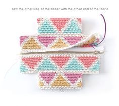 two crocheted wallets sitting next to each other