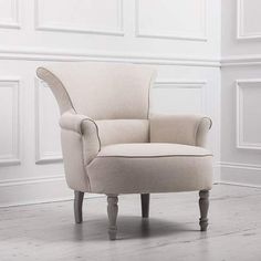 a white chair sitting on top of a hard wood floor