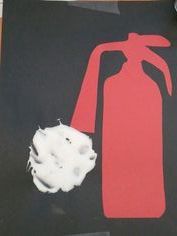 a red fire extinguisher next to a white object on a black surface