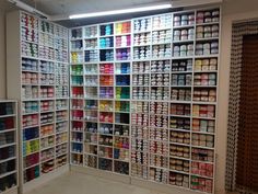 a room filled with lots of different types of paint and supplies on shelves next to each other