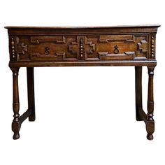 an old wooden table with many drawers on one side and two legs at the bottom