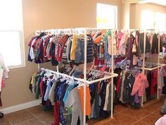 a child's clothing store with clothes on racks