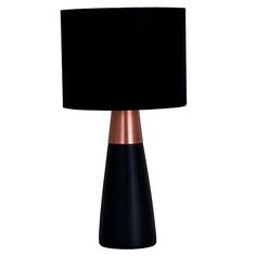 a black and copper lamp with a black shade on the top is sitting in front of a white background