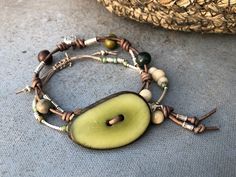 Olive Tagua Nut and Leather Bracelet, Ethnic Boho Bracelet, Tagua Nut Jewelry, Sundance Inspired jewerly, Leather knotted Bracelet Everyday Bohemian Wrap Bracelet With Sliding Knot, Bohemian Wrap Bracelet With Sliding Knot, Everyday Bohemian Nickel Free Wrap Bracelet, Rustic Green Adjustable Bracelet, Adjustable Rustic Green Bracelets, Adjustable Rustic Green Bracelet, Artisan Hand-tooled Jewelry Bracelet, Earthy Adjustable Hand-strung Bracelets, Hand-strung Bohemian Natural Jewelry