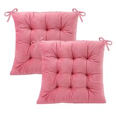 two pink pillows with bows on them