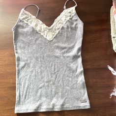 Hollister Tank Top Medium Lace Detail At The Top Excellent Condition Never Worn Fits Like A Sm Casual Tops With Lace Trim For Loungewear, Casual Lace Trim Camisole Top, Casual Cami Top With Lace Trim, Hollister Tank Tops, Hollister Tops, White Tank Top, White Tank, Lace Detail, Hollister