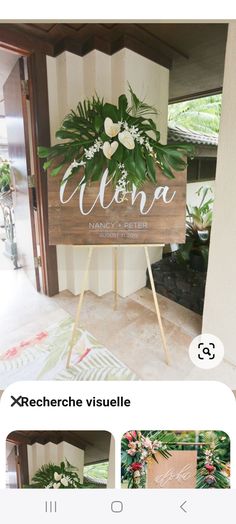 a sign that is sitting on top of a wooden stand with flowers and greenery