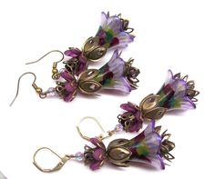 Boho earrings, flower earrings. Hand painted and color sealed (permanent) lilac purple flower earrings with a splash of olive green, burgundy and purple with lilac purple crystal accent beads. Dressed up or down no matter the occasion these colorful flower earrings are sure to compliment you. Earrings are large and lightweight and can be worn comfortably all day long. Earrings are recommended to those that are accustomed to wearing large earrings. Please refer to dimensions in description and ph Art Nouveau Earrings, Art Nouveau Earring, Blue Beaded Bracelets, Orange Earrings, Hippie Earrings, Painted Flower, Earrings Purple, Crystal Hoop Earrings, Crystal Dangle Earrings