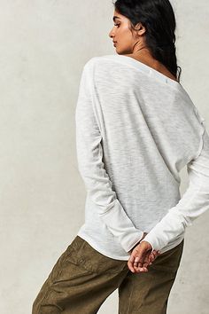 Add a cool and classic touch to your tops collection with this so cool long sleeve tee featured in a drapey, relaxed fit with subtle cowl-inspired neckline for added shape. **Fit:** Classic, relaxed fit **Features:** Wide neckline, exposed seaming, heathered fabrication **Why We | Kimmi Long Sleeve by Free People in White, Size: L Versatile Long Sleeve Tops For Casual Gatherings, Effortless Long Sleeve Tops For Casual Gatherings, Effortless Long Sleeve Tops For Fall, Relaxed Long Sleeve Tops For Casual Gatherings, Relaxed Tops For Casual Fall Gatherings, Chic Slouchy Tops For Spring, Relaxed Fall Tops For Casual Gatherings, Chic Long Sleeve Top With Relaxed Fit For Layering, Chic Relaxed Fit Long Sleeve Top For Layering