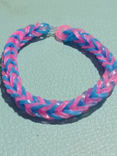 a pink and blue bracelet sitting on top of a table