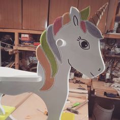 a wooden rocking horse that has been made to look like a unicorn's head