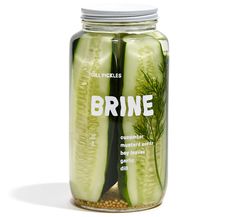 a jar filled with cucumber slices sitting on top of a table