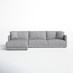 a gray couch sitting on top of a white floor