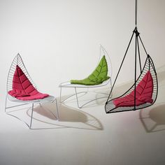 three chairs with different shapes and colors on the same chair, one is shaped like a leaf