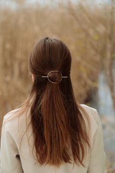 This oval hair slide in hammered brass, copper, or german silver will hold even the thickest tresses in place. Simply place the an oval over a twist, bun, or a pony, and use the stick to hold your hairdo in place. Each accessory is hammered by hand and tumbled for hours for strength and beautiful shine. *MEASUREMENTS AND DETAILS* - The barrette measures approximately 2.5" long and 2" wide - The pin is about 4" long - The barrette is hammered and curved to lay flat against your head - Metal: Copper / Rustic Copper / Brass / German Silver. German silver is a non-tarnish copper alloy (60%) with zink (20%) and nickel (20%). It is absolutely lead free and contains no silver! *The last picture is only a reference for the different types of metals used. For hairstyle tutorials and jewelry care in Oval Hair, Minimalist Hair Accessories, Metal Hair Accessories, Bun Holder, Twist Bun, Hairstyle Tutorials, Hammered Brass, Metal Hair, Jewelry Care Instructions