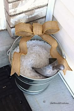 a metal bucket filled with white rice and a bow