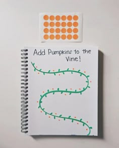 a spiral notebook with the words add pumpkins to the vine written in orange dots