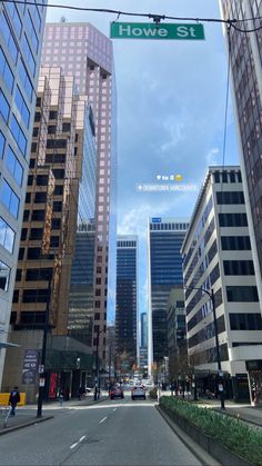 an empty city street with tall buildings in the background and a sign that says how st