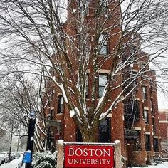 the boston university campus sign is covered in snow