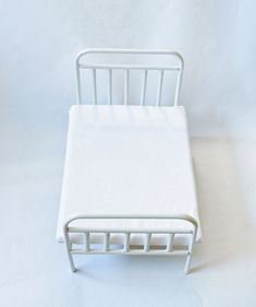 a small white bed frame on a white background