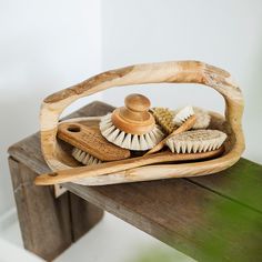 a wooden brush holder filled with different types of brushes