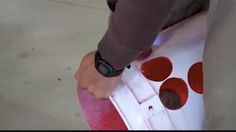 a person standing on top of a red skateboard